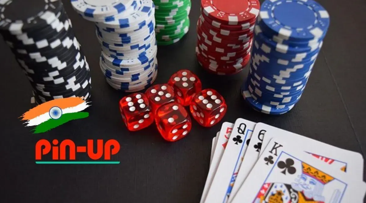 Stacks of casino chips, red dice and playing cards with the Pin-Up logo and an Indian flag